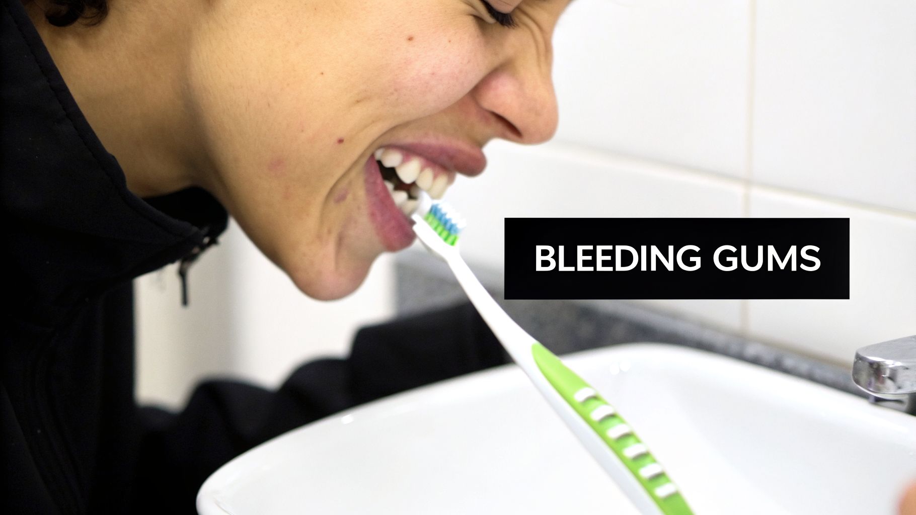 A person grimacing while brushing their teeth with a toothbrush over a sink, illustrating bleeding gums.